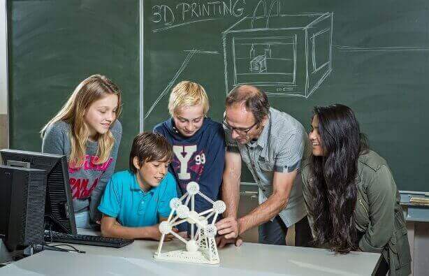 What’s wrong with this picture? If everything works out fine, the kids will have to teach the grown-ups on how to use a 3D printer. image: Materialise)
