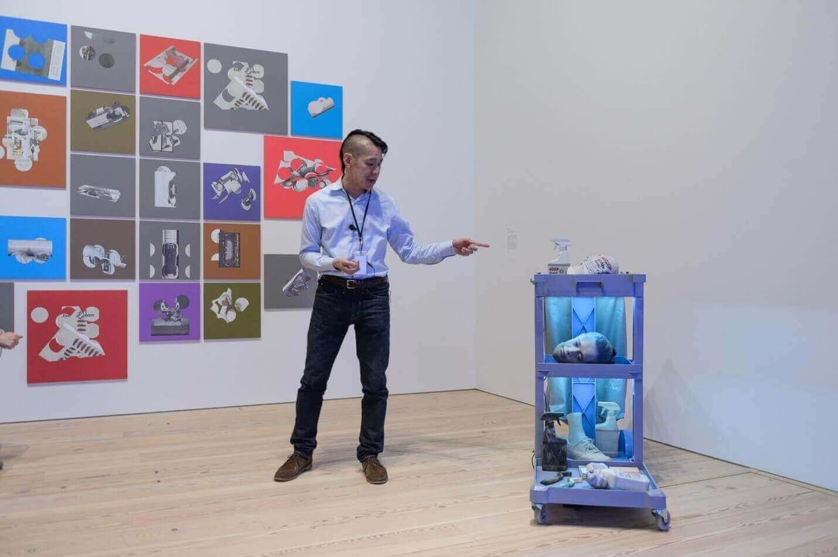 Curator Lew discussing the "Cost of Living" (Image: Filip Wolak)