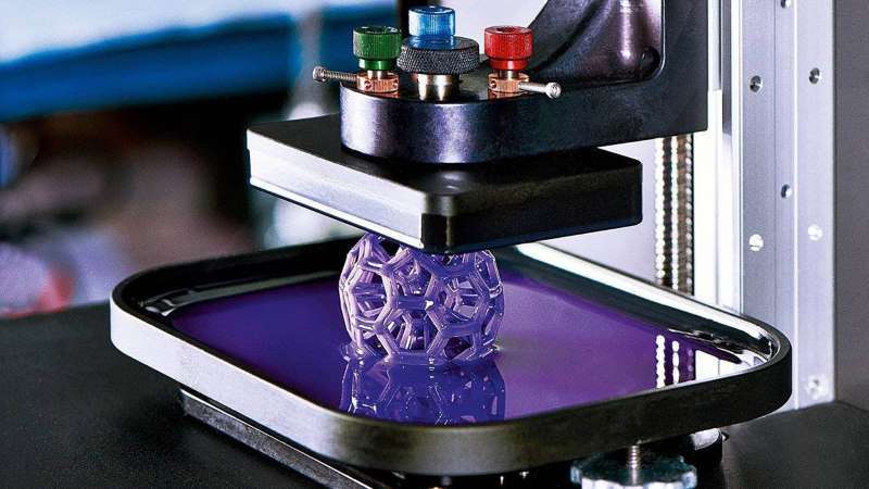 An SLA print emerges from the vat of resin