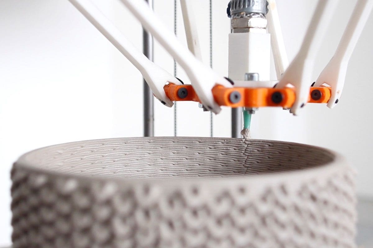A delta printer up close, printing ceramic.