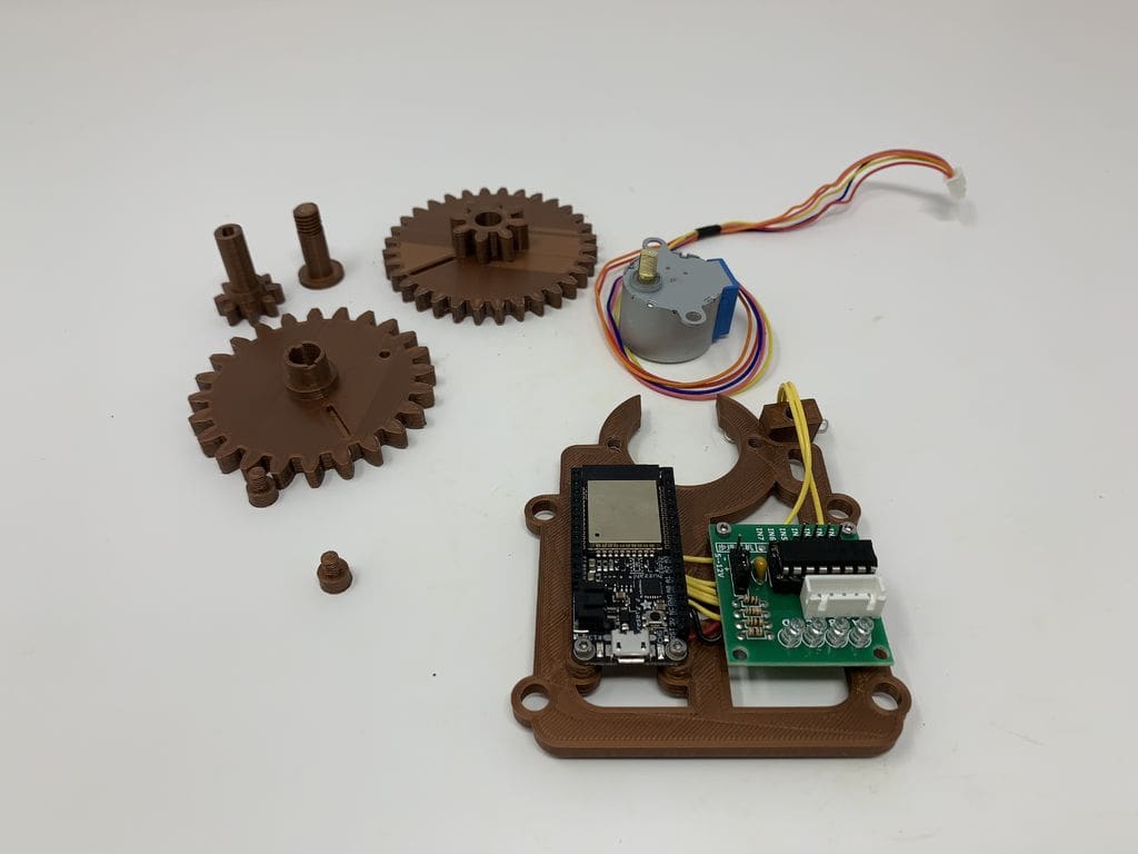 The 3D printed parts, motor, ESP32 Feather Board, and controller.