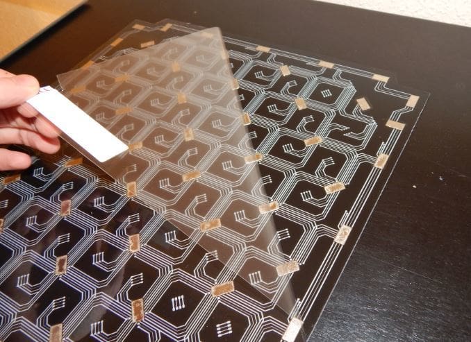 Peeling the plastic from the adhesive back on the magnetic plate.