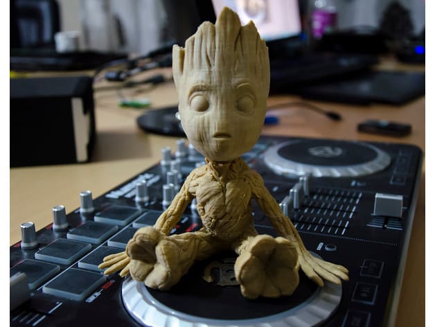 Baby Groot resting his limbs.
