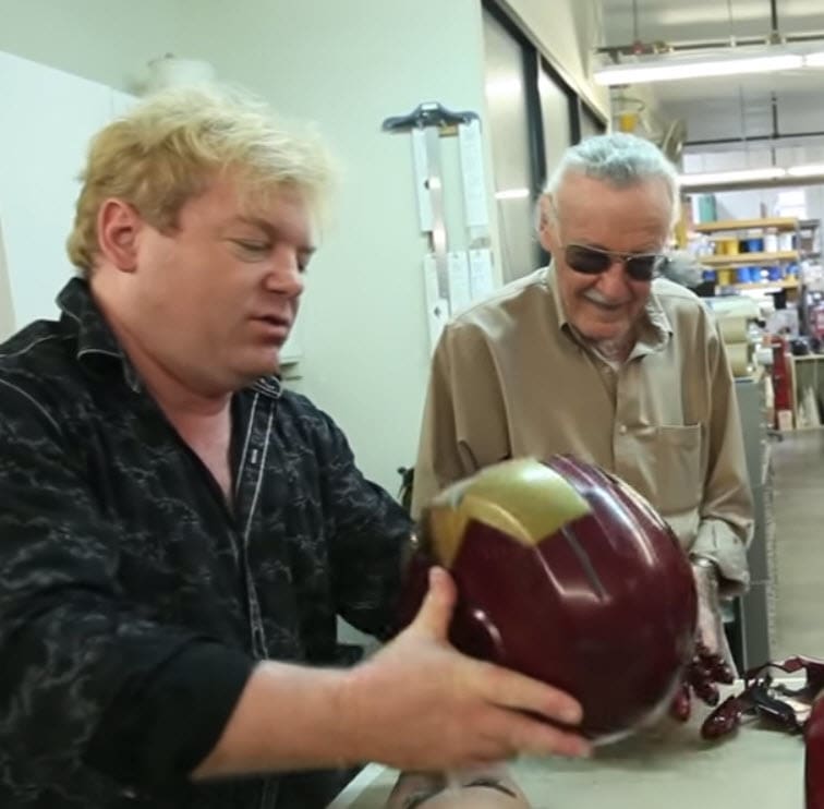 Stan Lee checking out a 3D printed and cast Iron Man helmet.