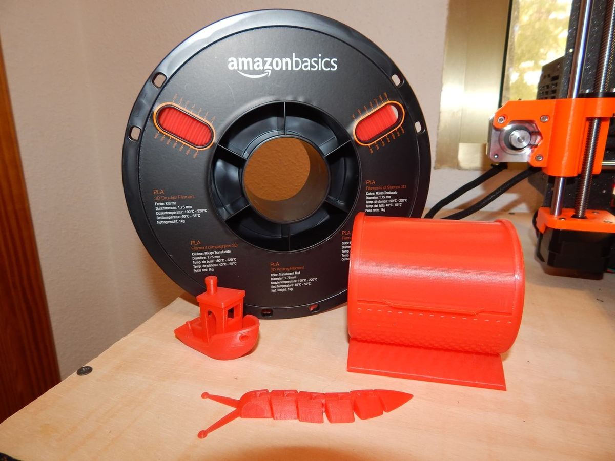 The spool of PLA alongside our test prints.