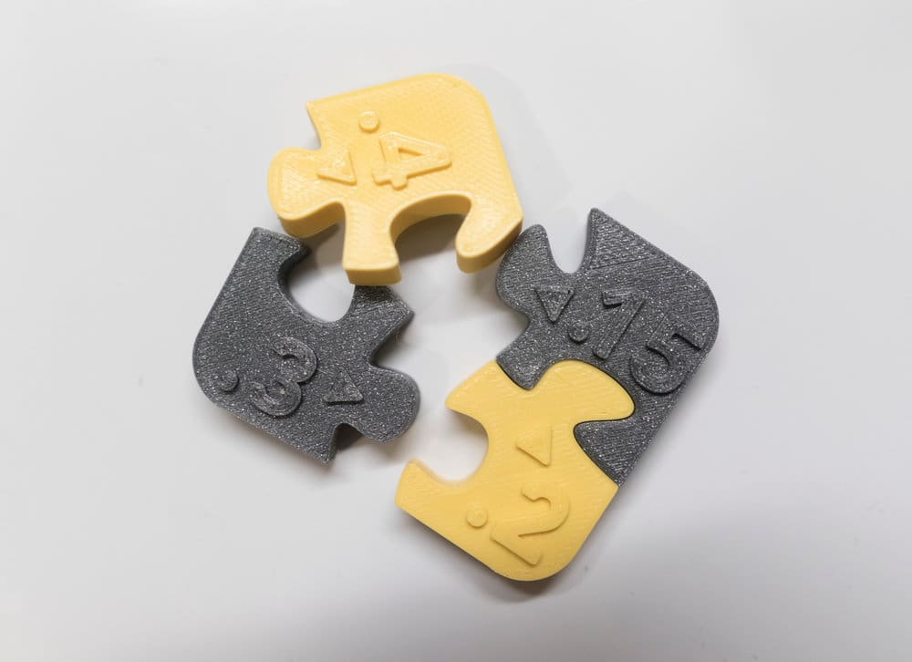 Puzzle pieces with different values of clearance.