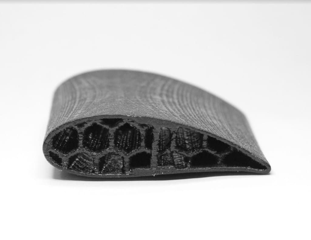 A machine piece 3D printed in Kevlar.