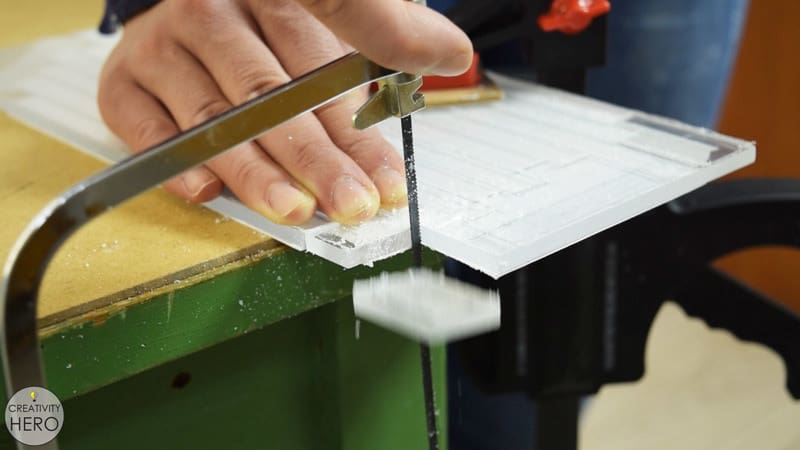 Hand-sawing acrylic with a metal-cutting hacksaw (note the fine saw teeth!)