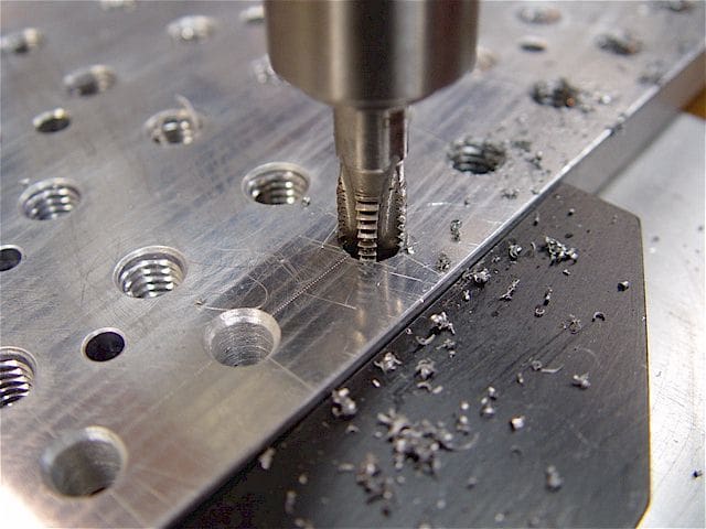 Threaded holes in a machined part.