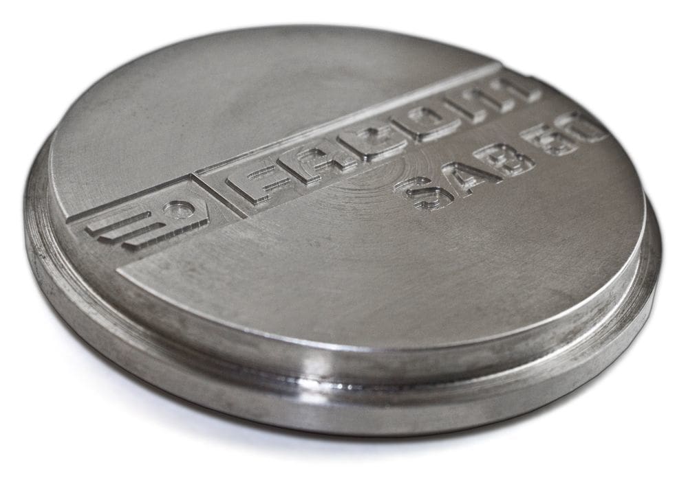 Engraving over embossing on machined parts.