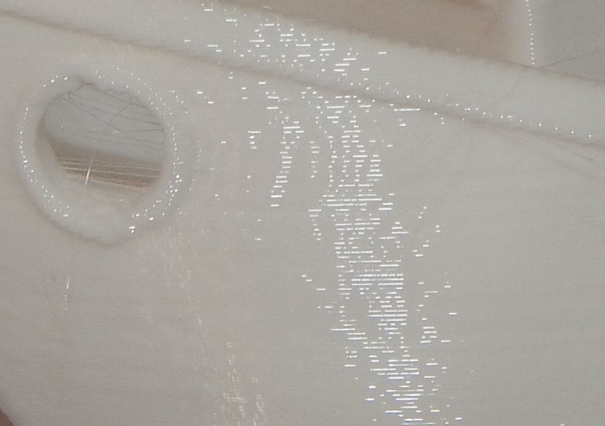 A close-up shows good adhesion between layers.