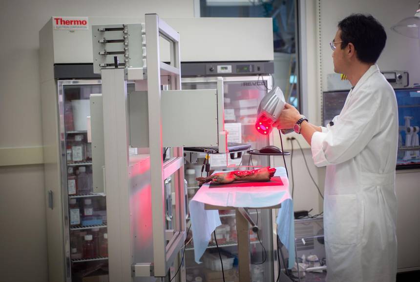 A researcher scans a model hand to test the printer