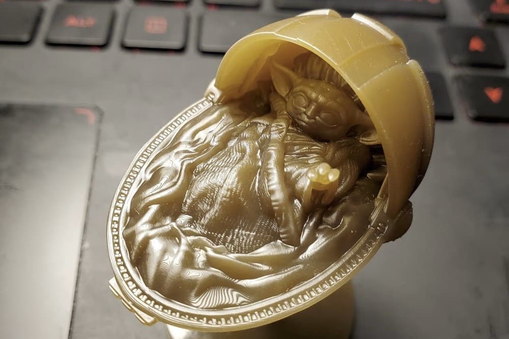A resin print of Baby Yoda in his crib
