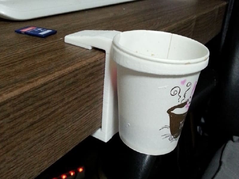 This nifty cup holder clamps onto desks and tables, making it very versatile