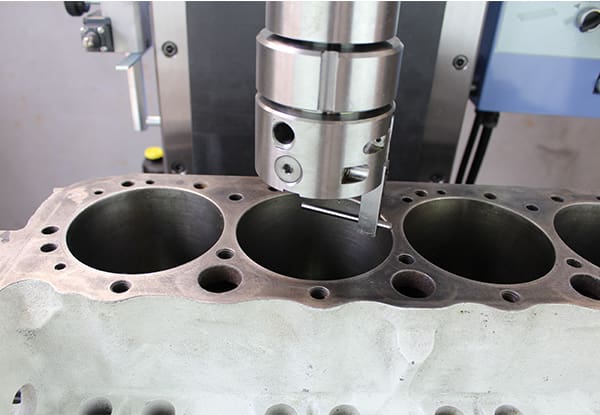 A boring machine creating the hole for an engine cylinder