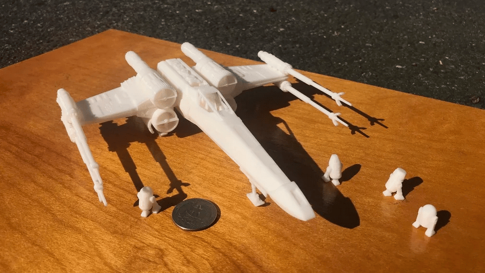 The coin in the foreground shows the scale of this fighter