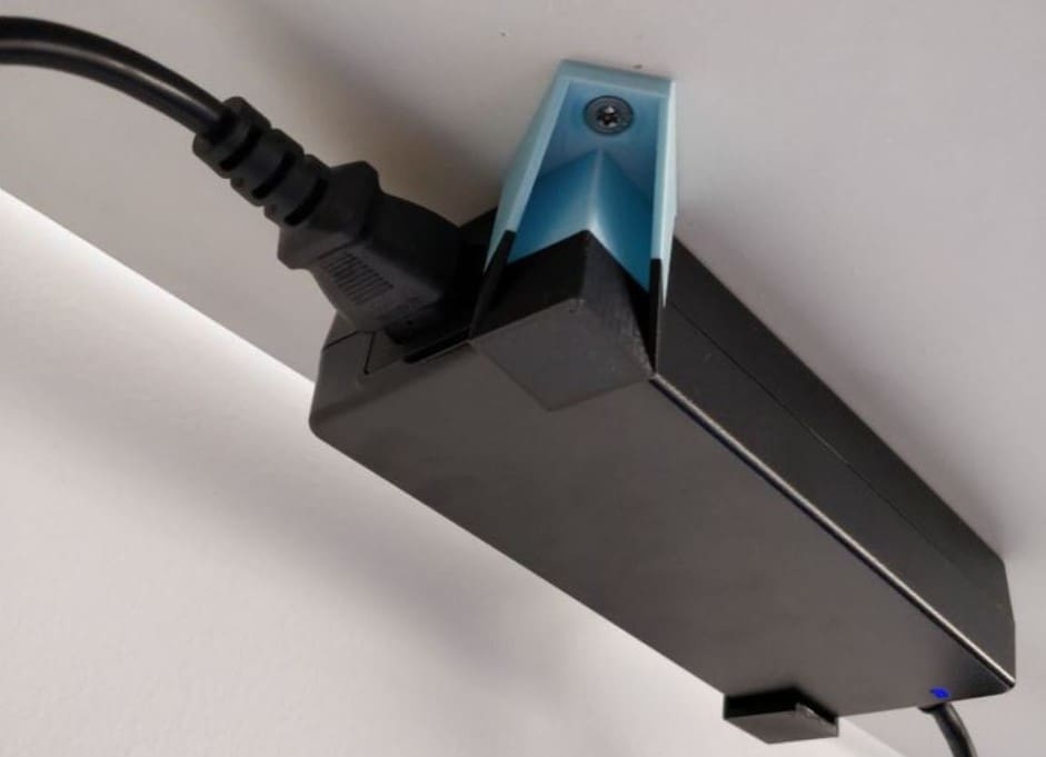 The power supply held to the underside of a table