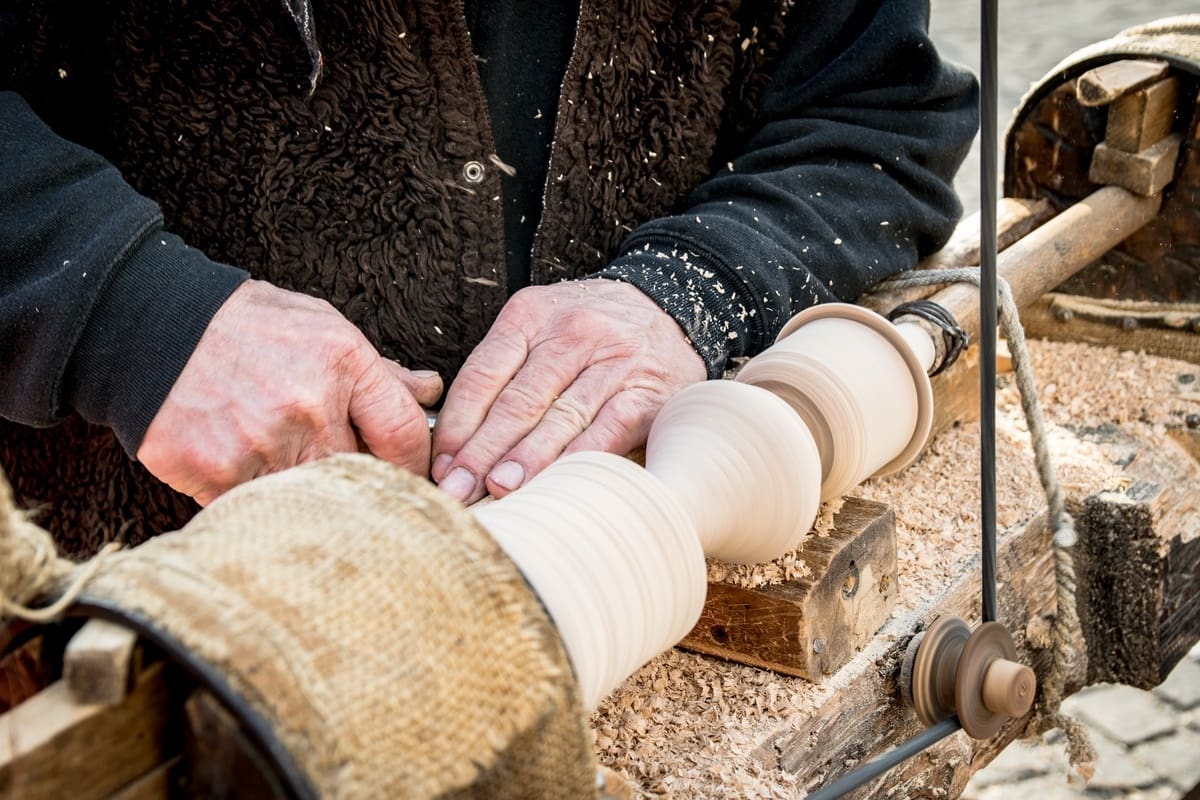 The table leg being turned here is a great example of bespoke furniture still made by hand