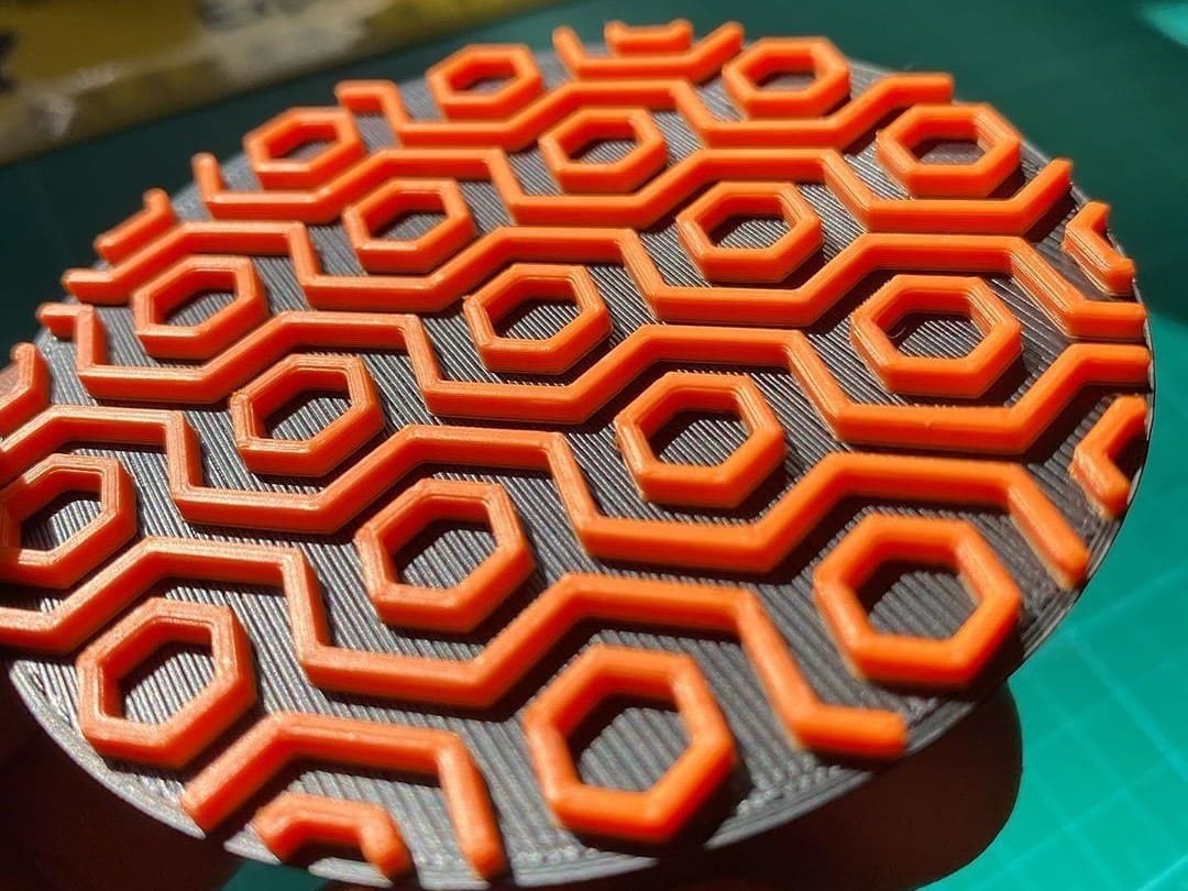 Black ABS+ and orange ABS working in unison in this drink coaster