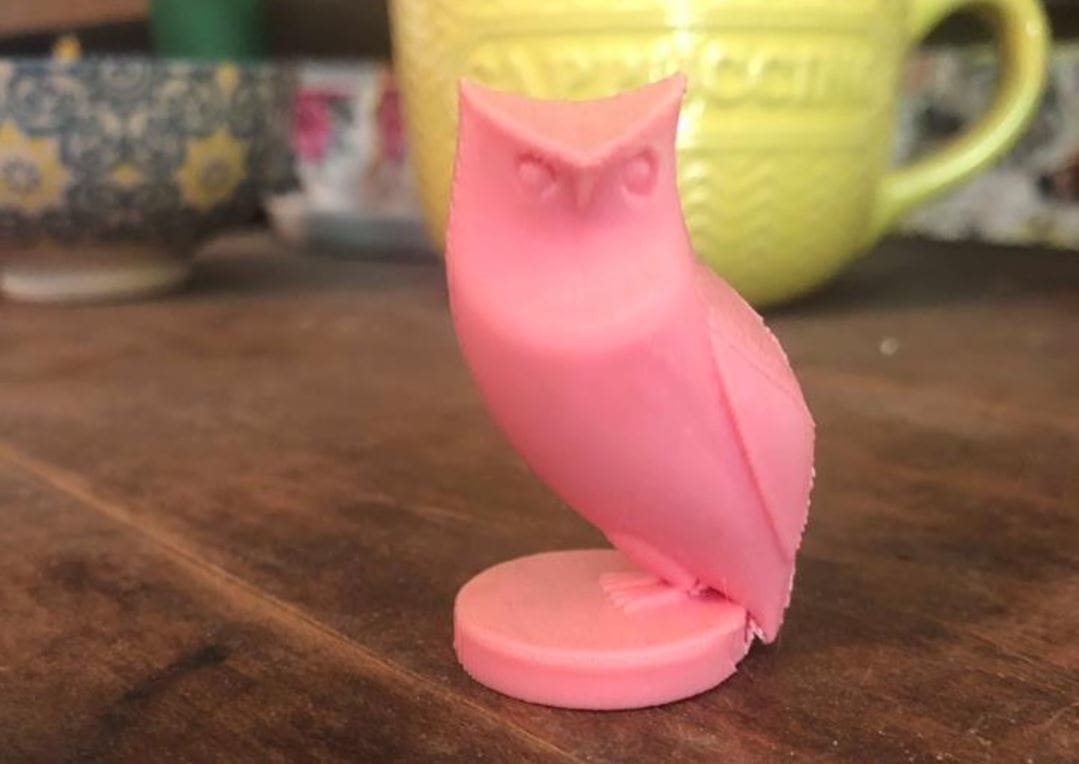 This simple owl is perched on a circular platform