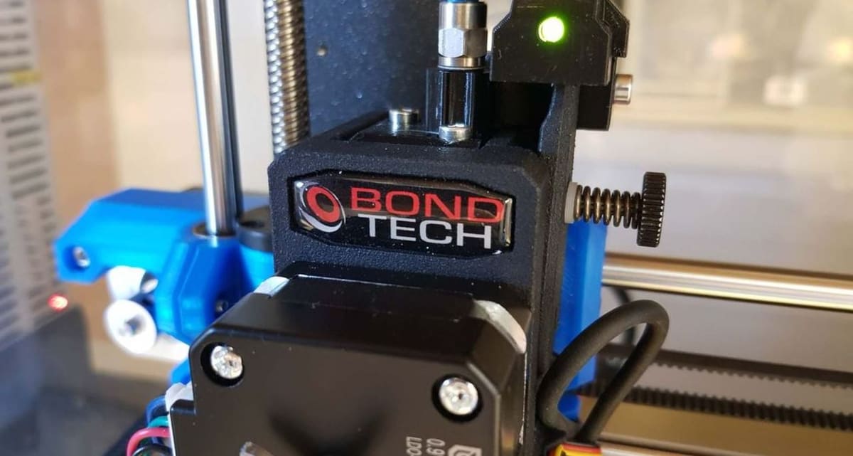 The BMG extruder has a tension adjustment screw
