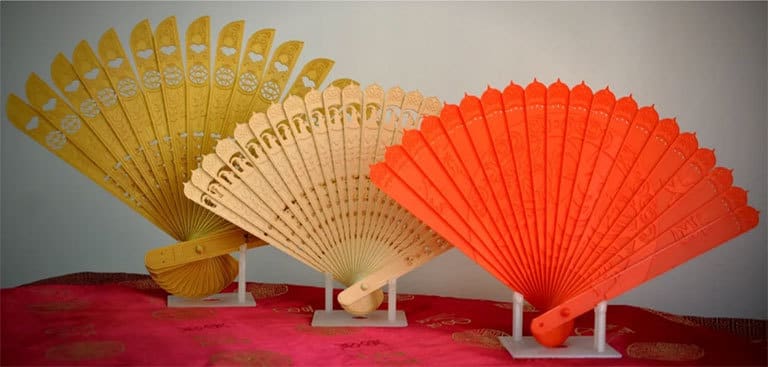 Three oriental folding fans made with wood PLA, gold PLA and red PLA