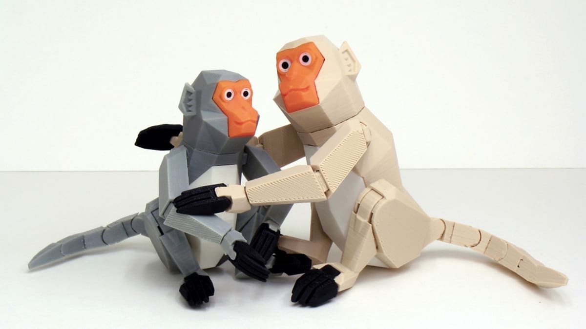 Two friendly monkey figurines with bendable limbs and tail