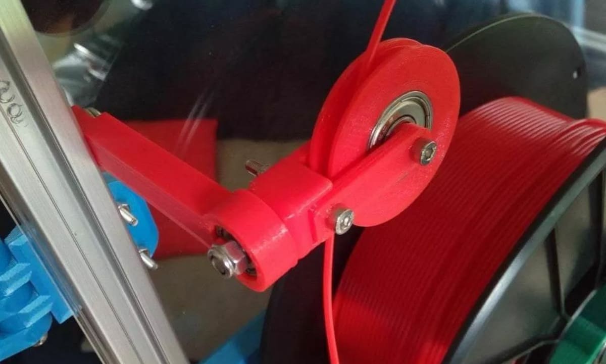 This filament guide can mount to your printer's frame using the mounting hole