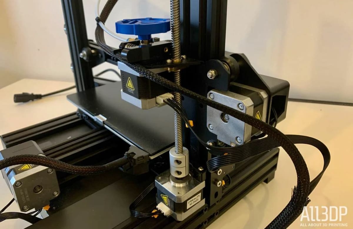 The Ender 3 V2 uses a Bowden drive extruder with a plastic extruder assembly