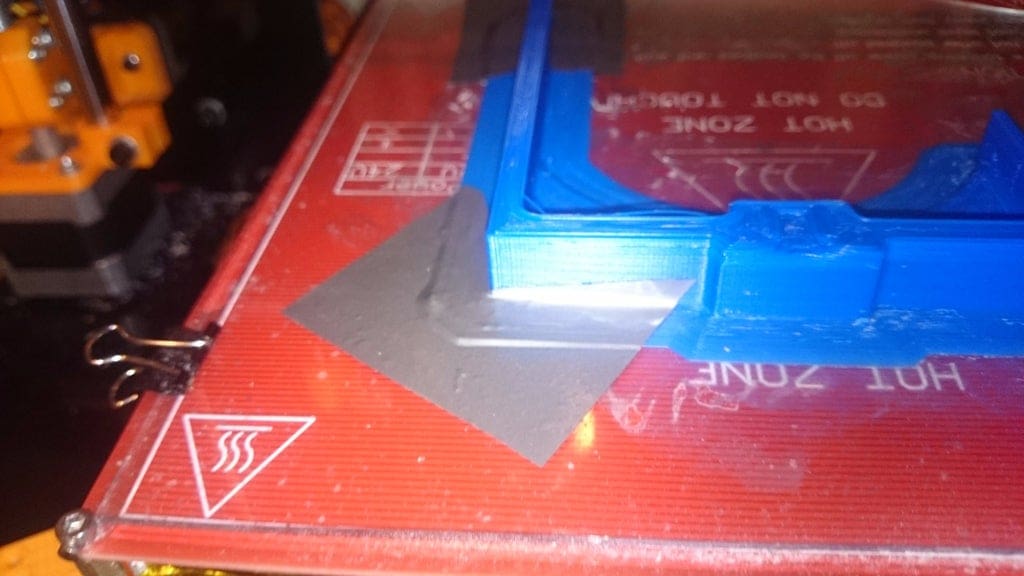 Even duct tape can be used to save a warping print from coming off the build plate