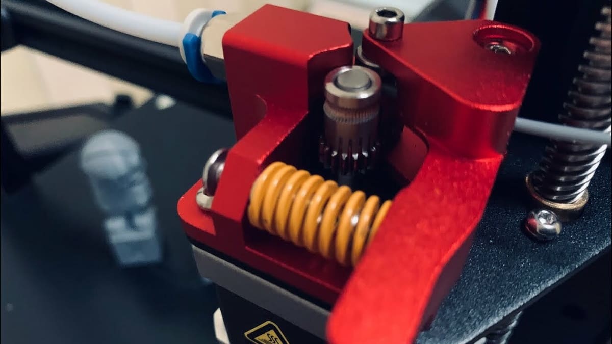 The metal arm and yellow compression spring are a much needed upgrade