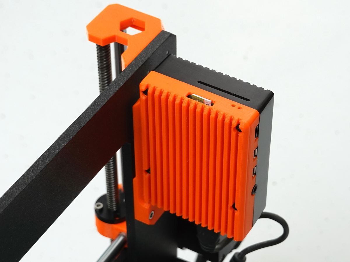 A custom Raspberry Pi enclosure connected to a Prusa MK3