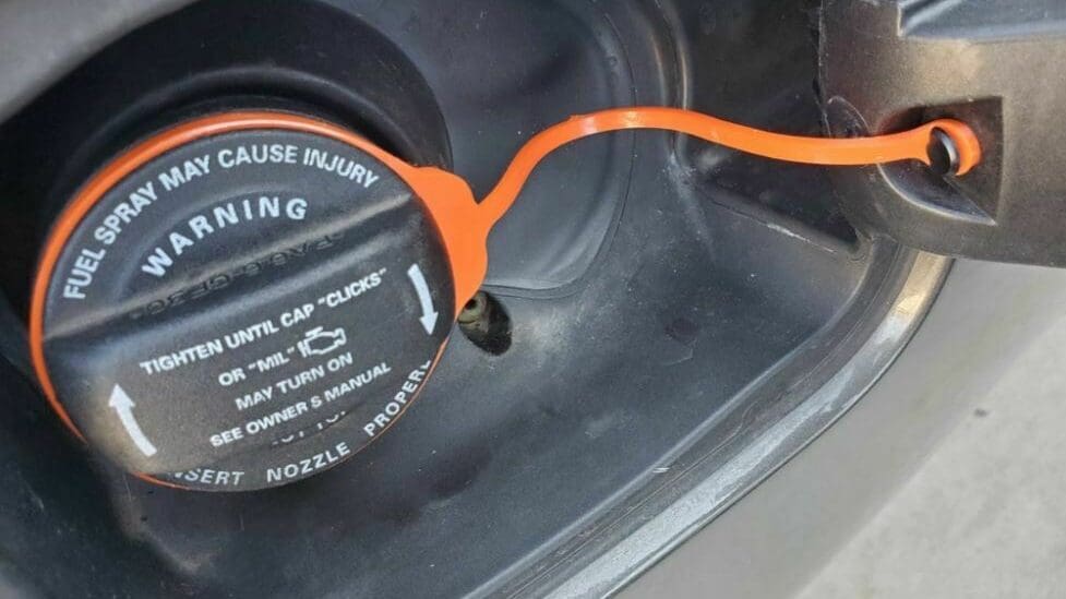 This gas cap tether should be printed in a flexible filament so the cap can move freely