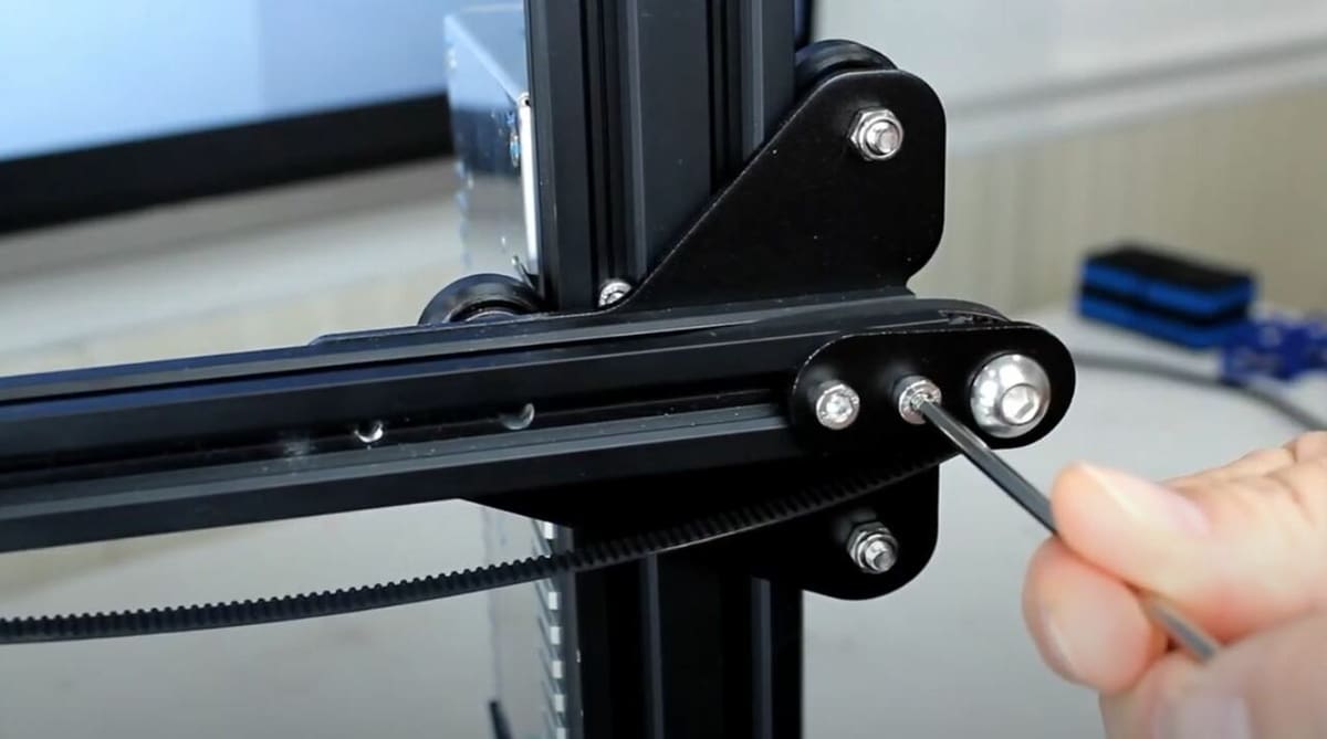 To tighten your 3D printer's belts, loosen the idler pulley, pull it away from the other end of the axis, and re-tighten