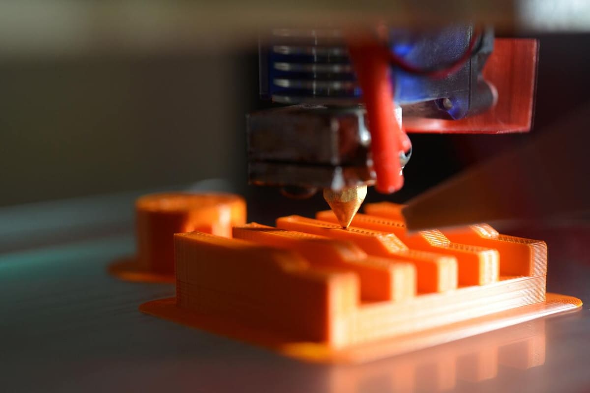 The hot end of a Mendel90 RepRap 3D printer in action