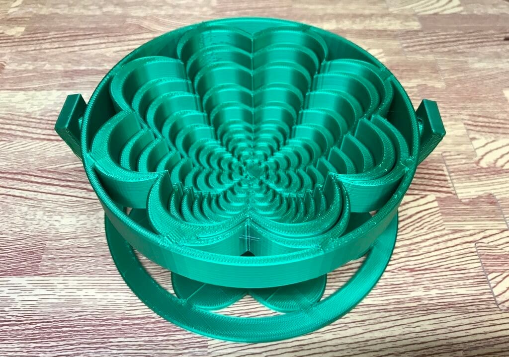 This clover shaped design can be used as a trivet when flat or as a bowl or basket when extended