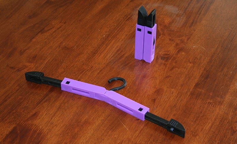 This portable hanger has two integrated hinges that allow you to fold it