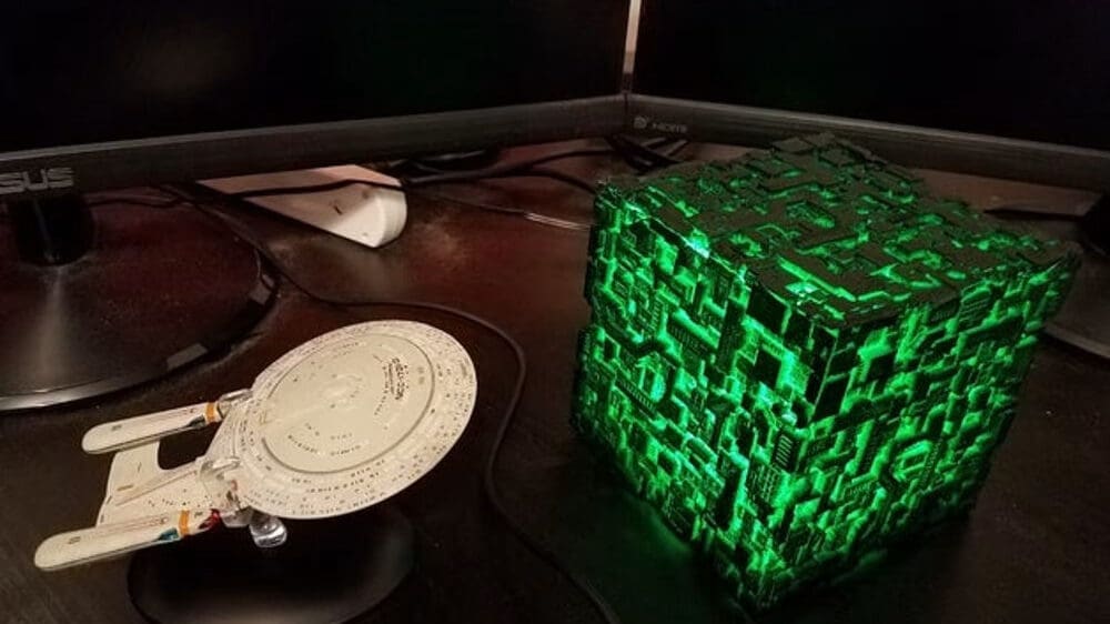 A Borg cube with transparent green filament and LED inside