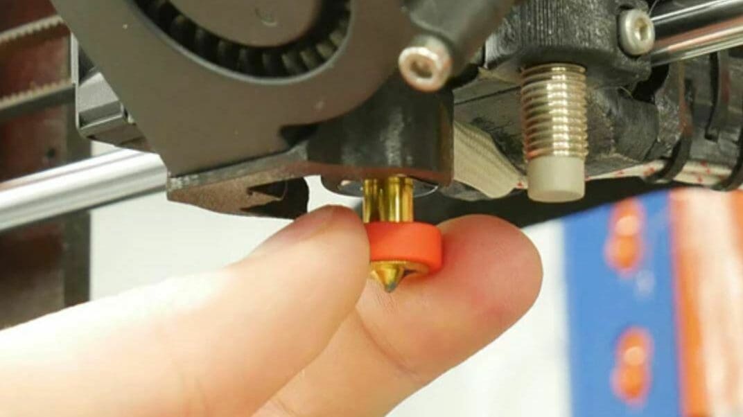 You can change the nozzle by hand on a Revo hot end
