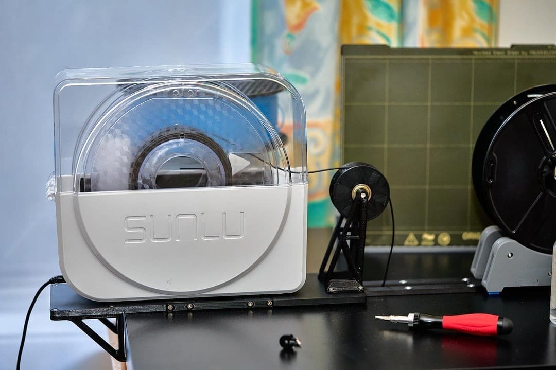 You can feed filament directly from the dryer to your hot end!