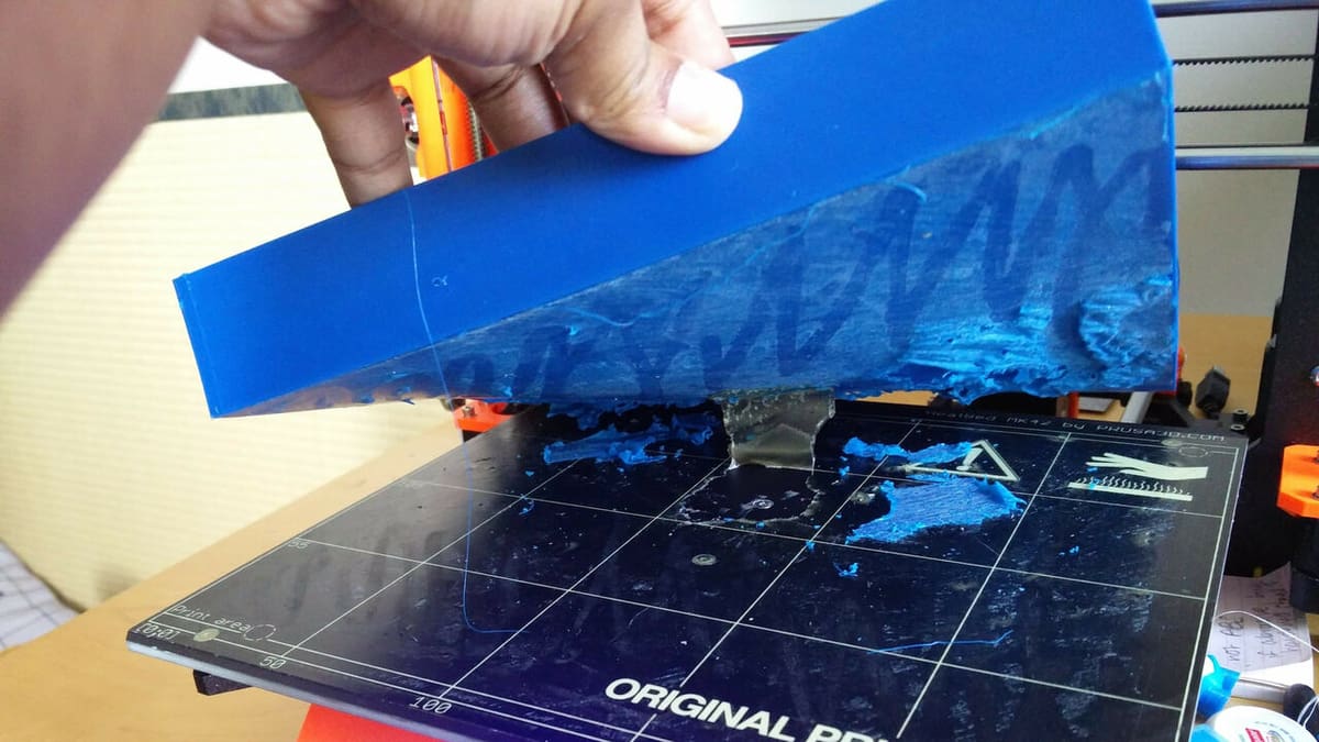 You'll need a scraper to safely remove the printed part from the build plate