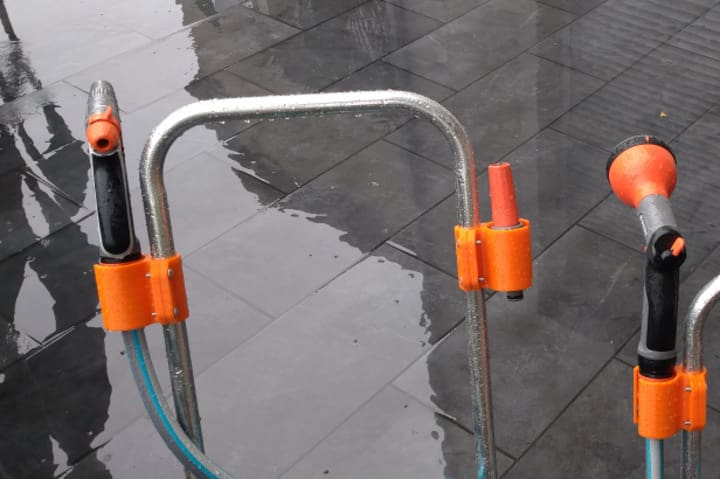 Clamp this adapter near your garden hose to hold the nozzle