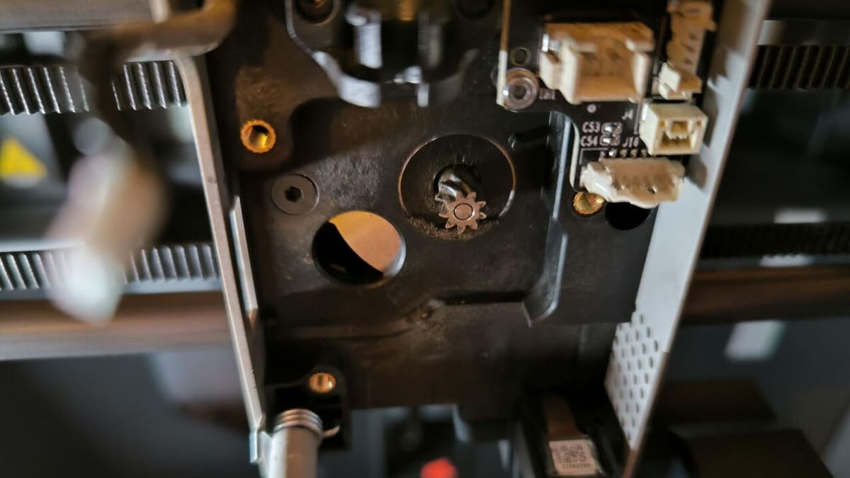 The Bambu Lab X1C's extruder assembly before cleanup