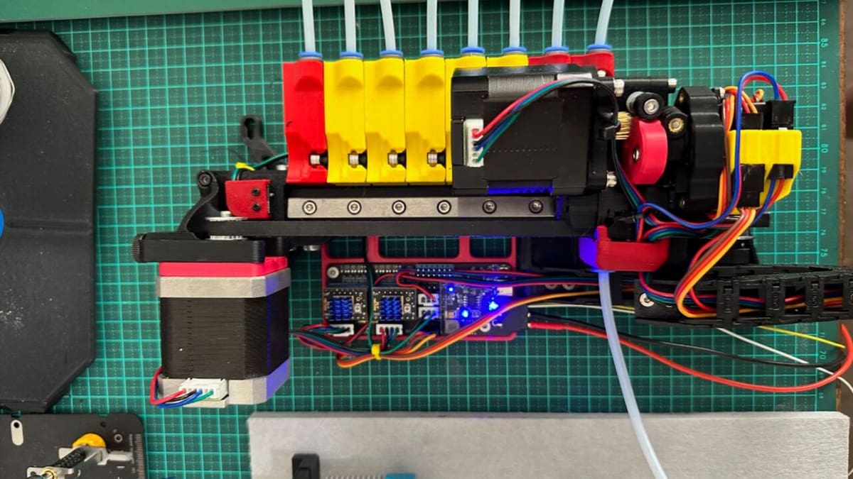It only uses three motors (two stepper, one servo) for filament switching